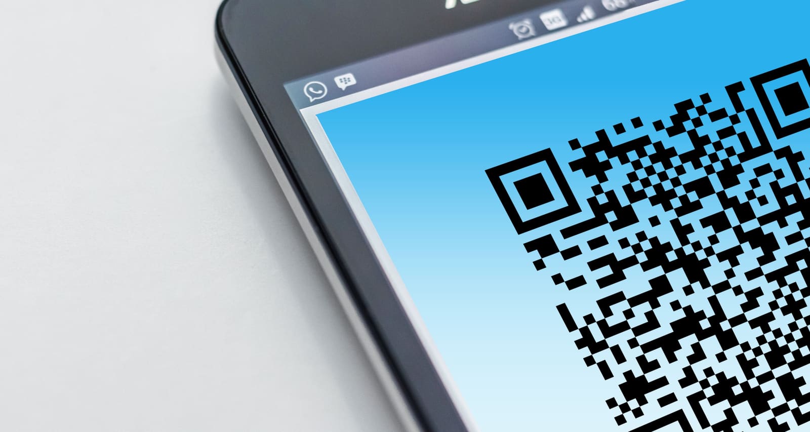 A smartphone camera scanning a QR code displayed on a screen
