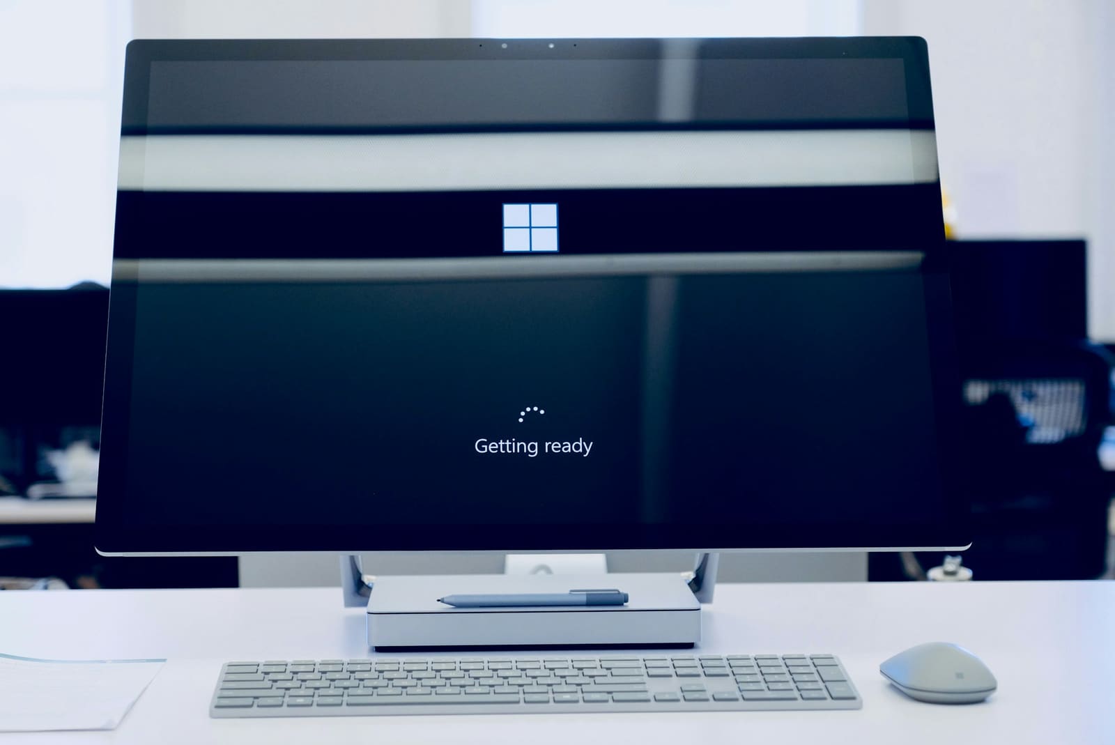 A flat screen computer monitor turned on at a desk